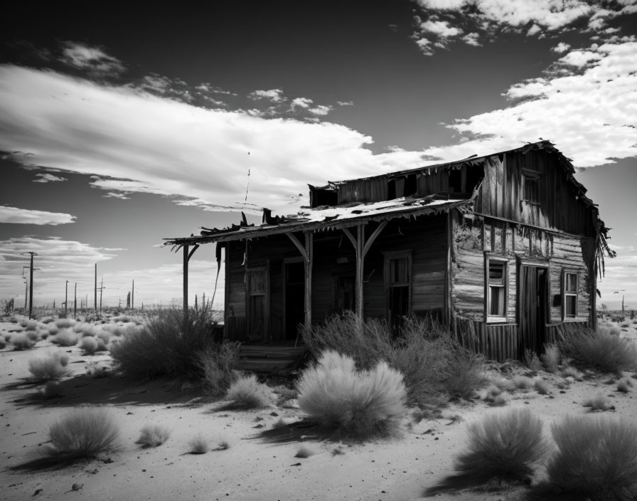 Abandoned wooden house with collapsed roof in desert landscape