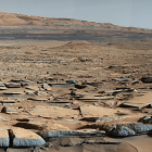 Futuristic desert landscape with scattered settlements and distant metropolis