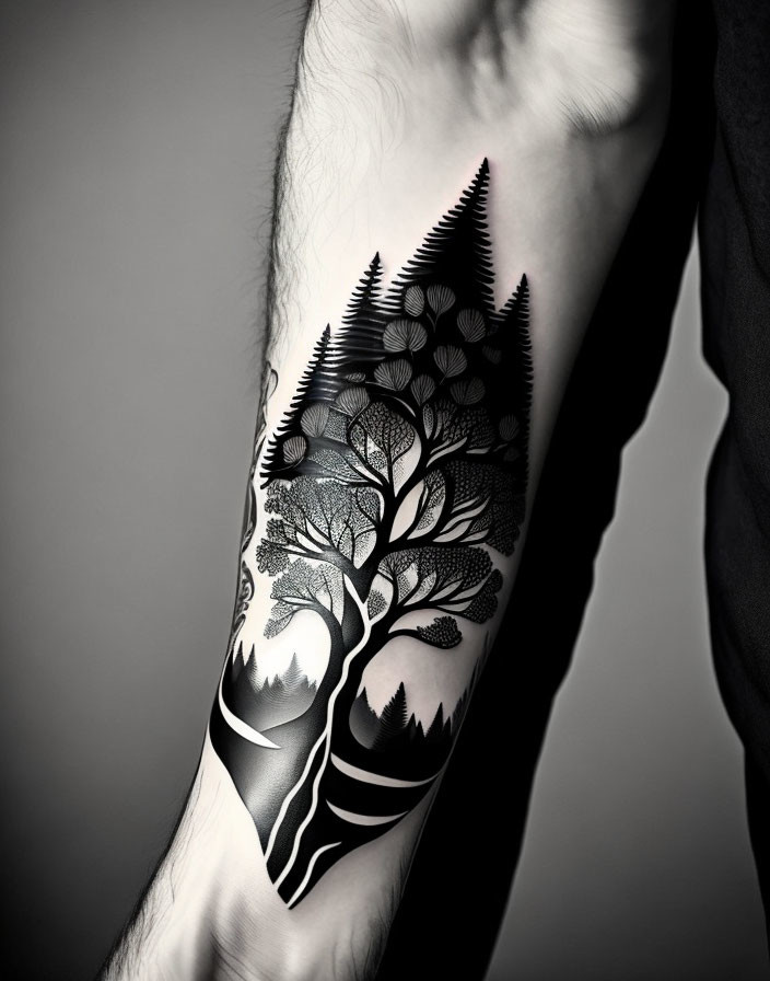 Monochrome forearm tattoo of forest, moon, mountain