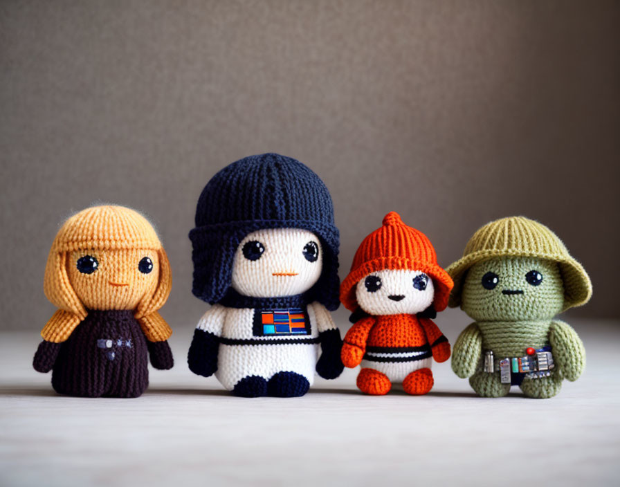 Crochet dolls of iconic sci-fi characters on neutral background