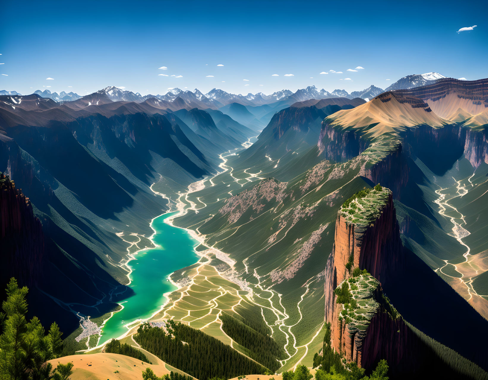 Serpentine River in Deep Valley with Snow-Capped Mountains