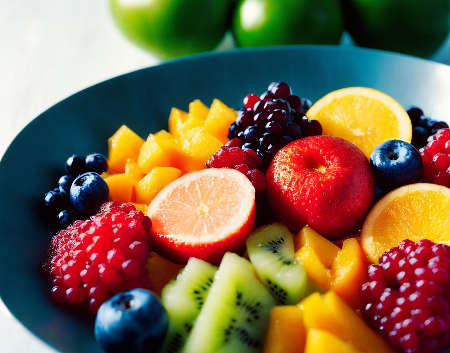 Vibrant mixed fruit bowl with strawberries, blueberries, kiwi, mango, and citrus slices