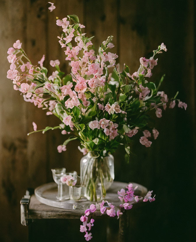 Pink Flowers Bouquet in Glass Vase on Wooden Table