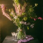 Pink Flowers Bouquet in Glass Vase on Wooden Table