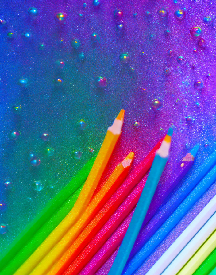 Vibrant diagonal pencils on gradient background with water droplets