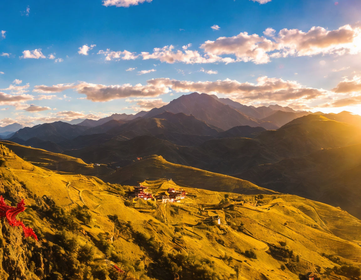 Golden sunrise over mountain landscape with traditional temple and vibrant sky