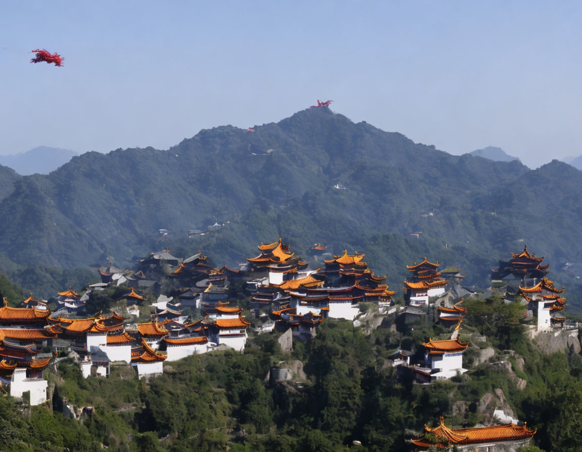 Chinese Temple Complex Surrounded by Mountains and Blue Sky