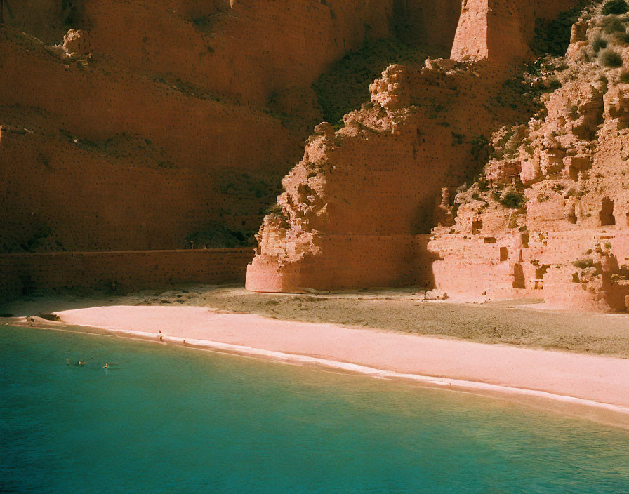 Scenic Beach with Turquoise Water and Reddish Cliffs