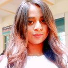 Blonde woman with wavy hair in white top and flower crown