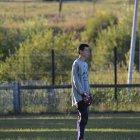 Soccer field scene with person, landscape, and soccer balls.