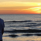 Galaxy print shirt person gazes surreal sunset landscape