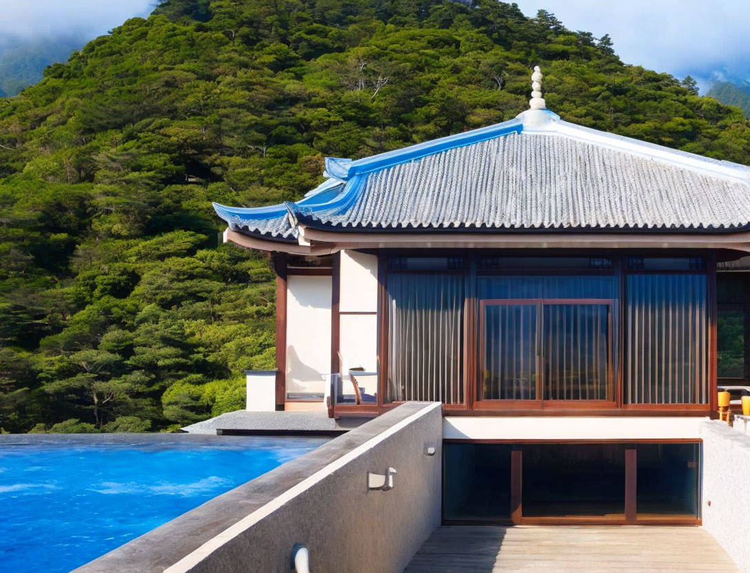 Asian-style Building with Blue-Tiled Roof and Infinity Pool Amid Green Mountains