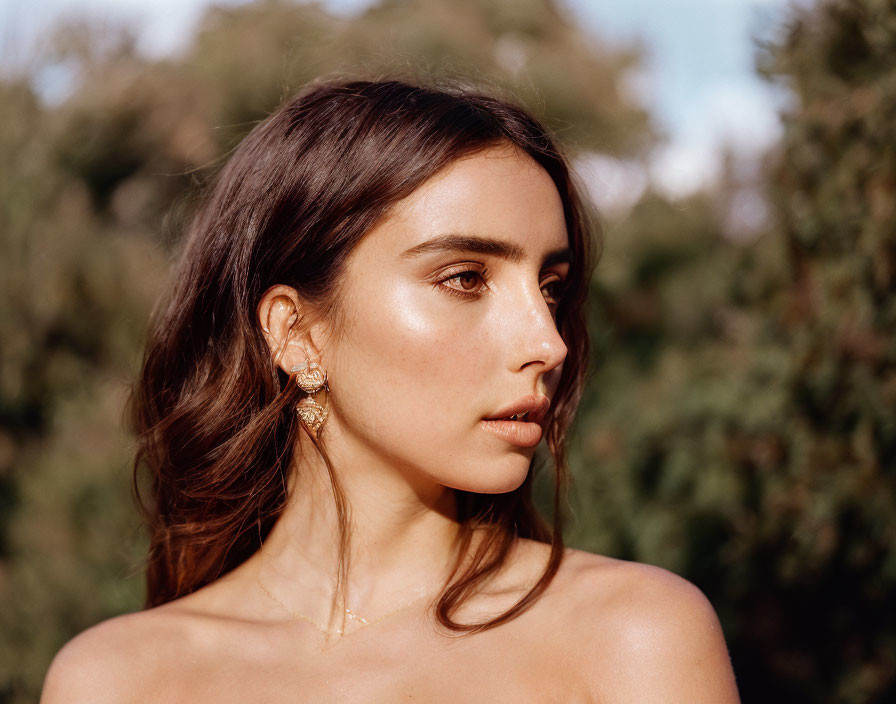 Dark-Haired Woman with Golden Earrings in Natural Light