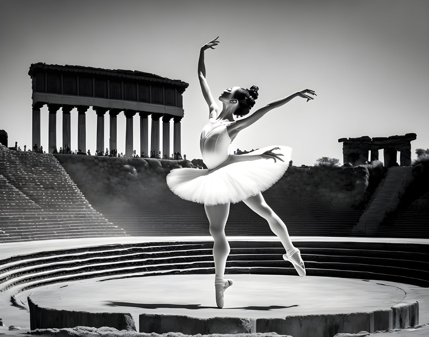 Ballet dancer in white tutu poses in ancient amphitheater