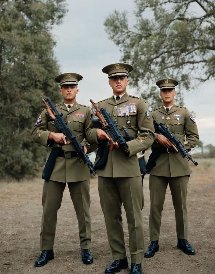 Uniformed personnel with rifles in formation outdoors under cloudy sky