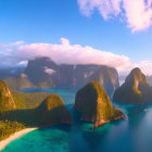 Tropical landscape with green mountains, blue waters, beach, boats, and sunset sky