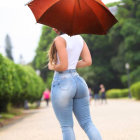 Stylish woman with vibrant umbrella in autumn setting