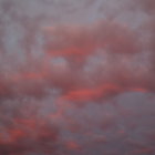 Alien landscape with ancient ruins under pink sky & setting sun