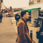 Person with umbrella and face mask talks to futuristic robot on rain-slicked city street