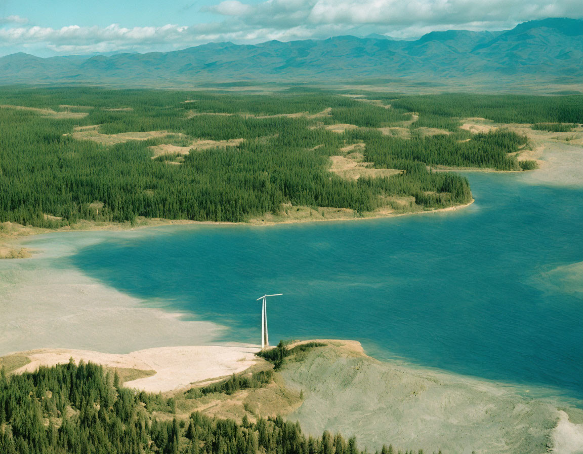 Tranquil lake, forest, wind turbine, hills in aerial view