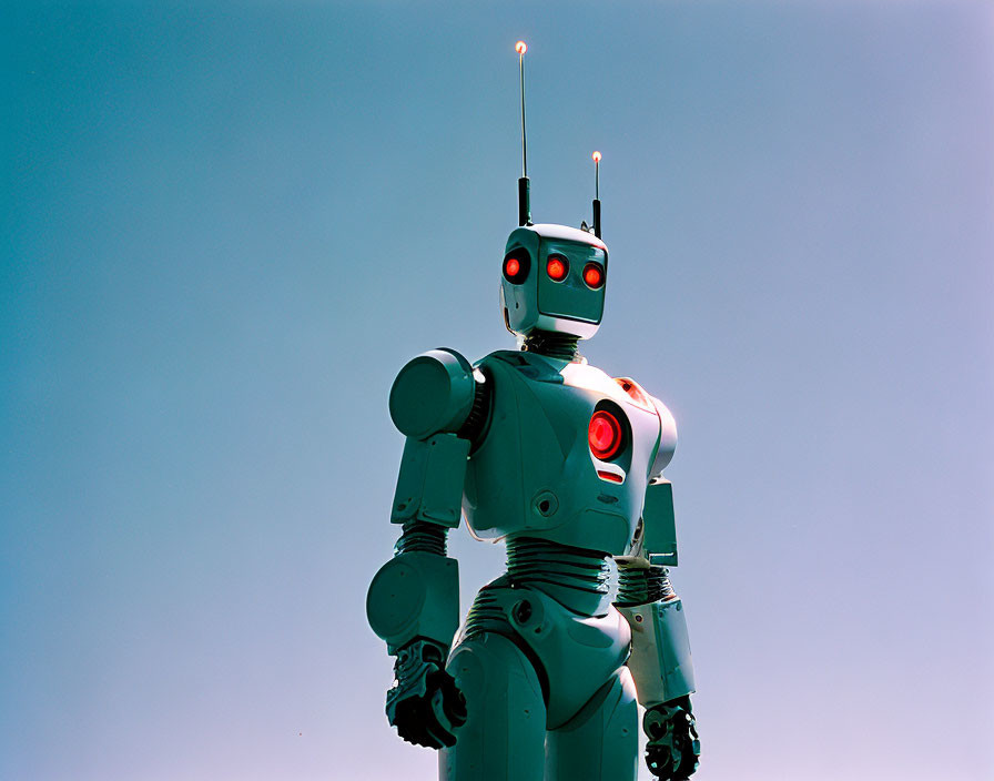 Red-eyed humanoid robot with antennae against blue sky, illuminated chest