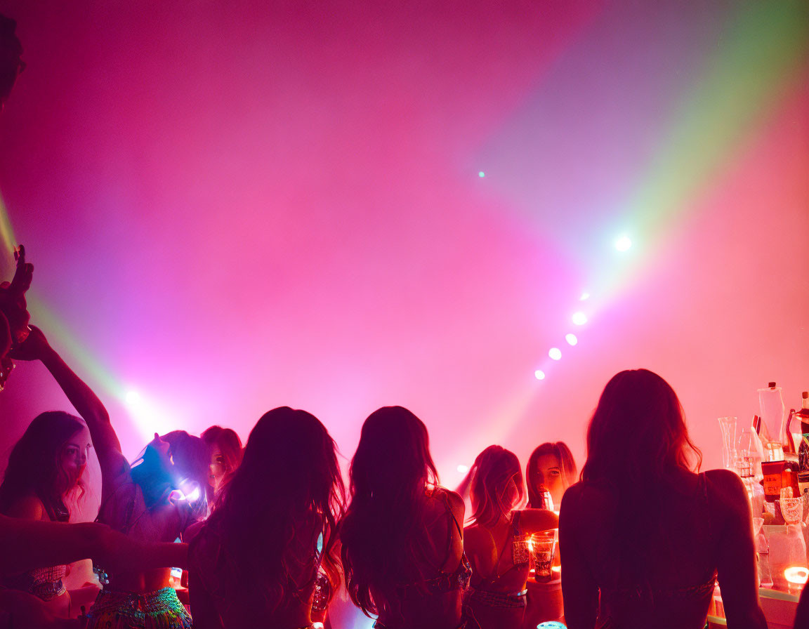 Vibrant party scene with colorful lights and silhouetted figures