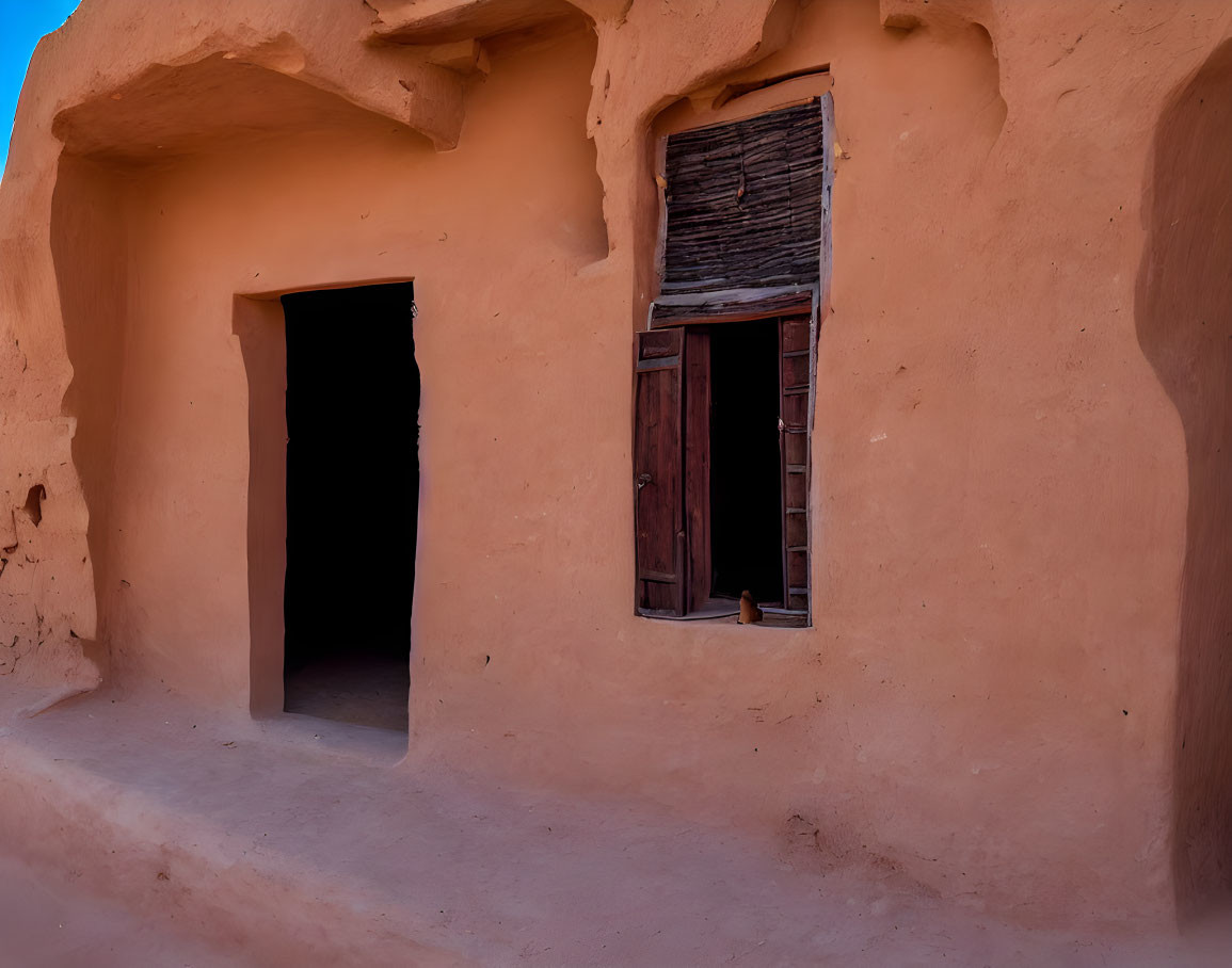 Traditional Earthen Structure with Textured Facade and Wooden Window