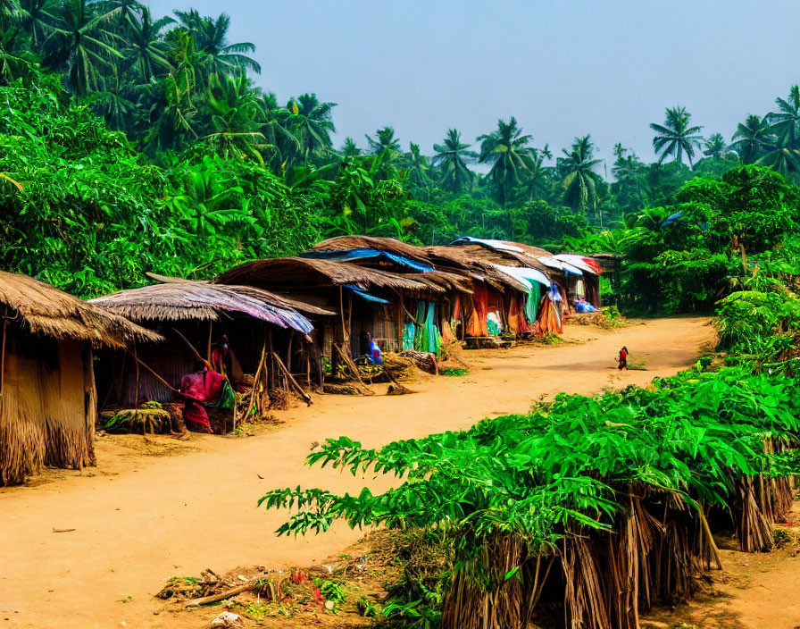 Tropical village with thatched huts and lush greenery