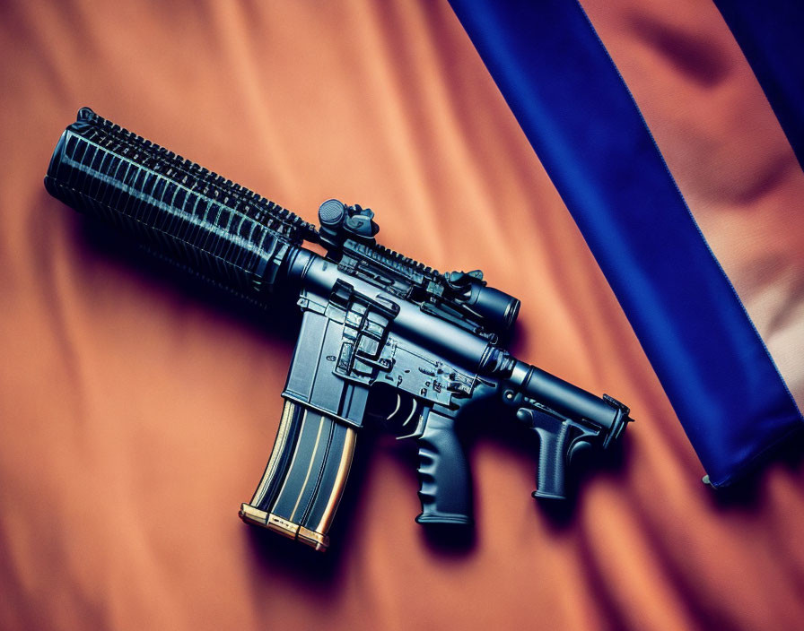 Black AR-15 Style Rifle with High-Capacity Magazine on Orange Surface