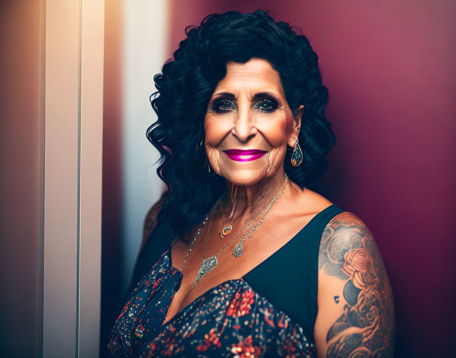 Elderly Woman in Floral Dress with Tattooed Arms on Red Background