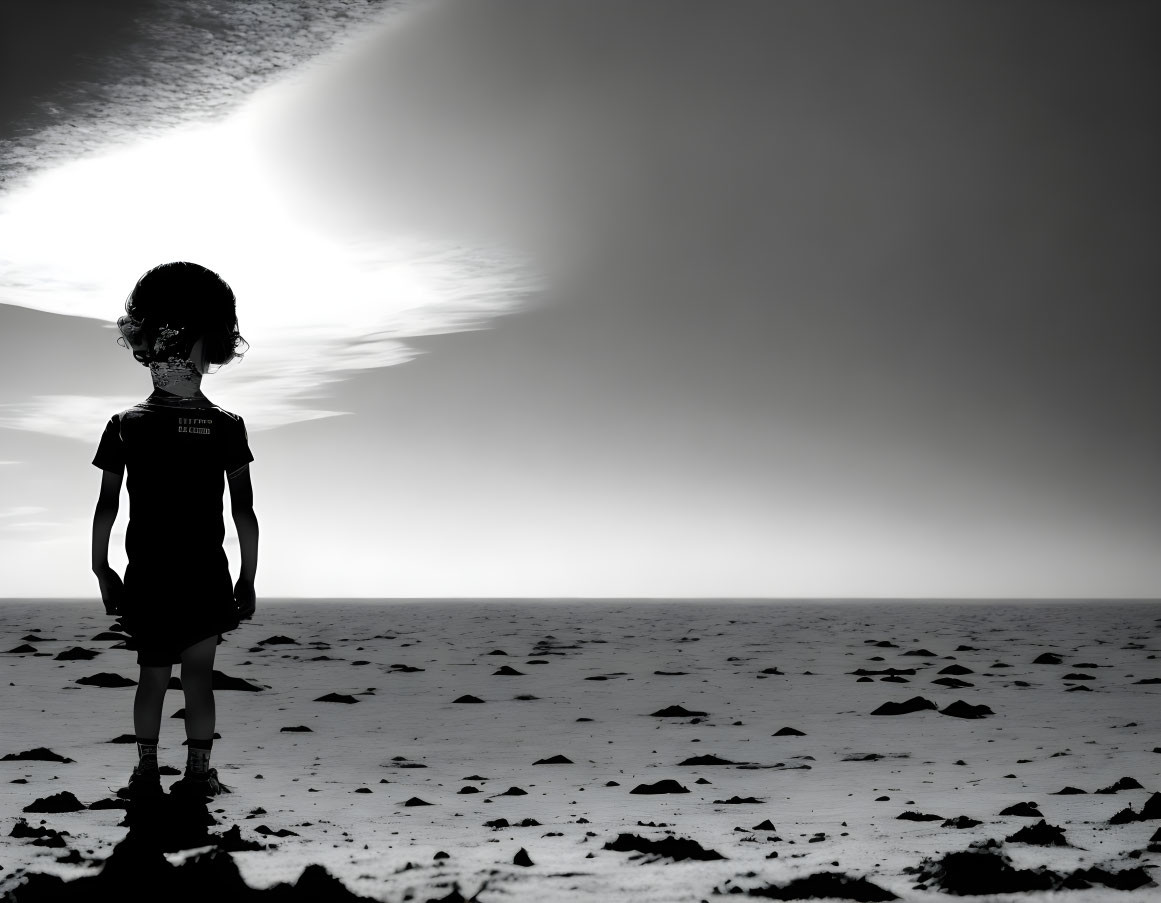 Monochromatic photo of child in stark landscape