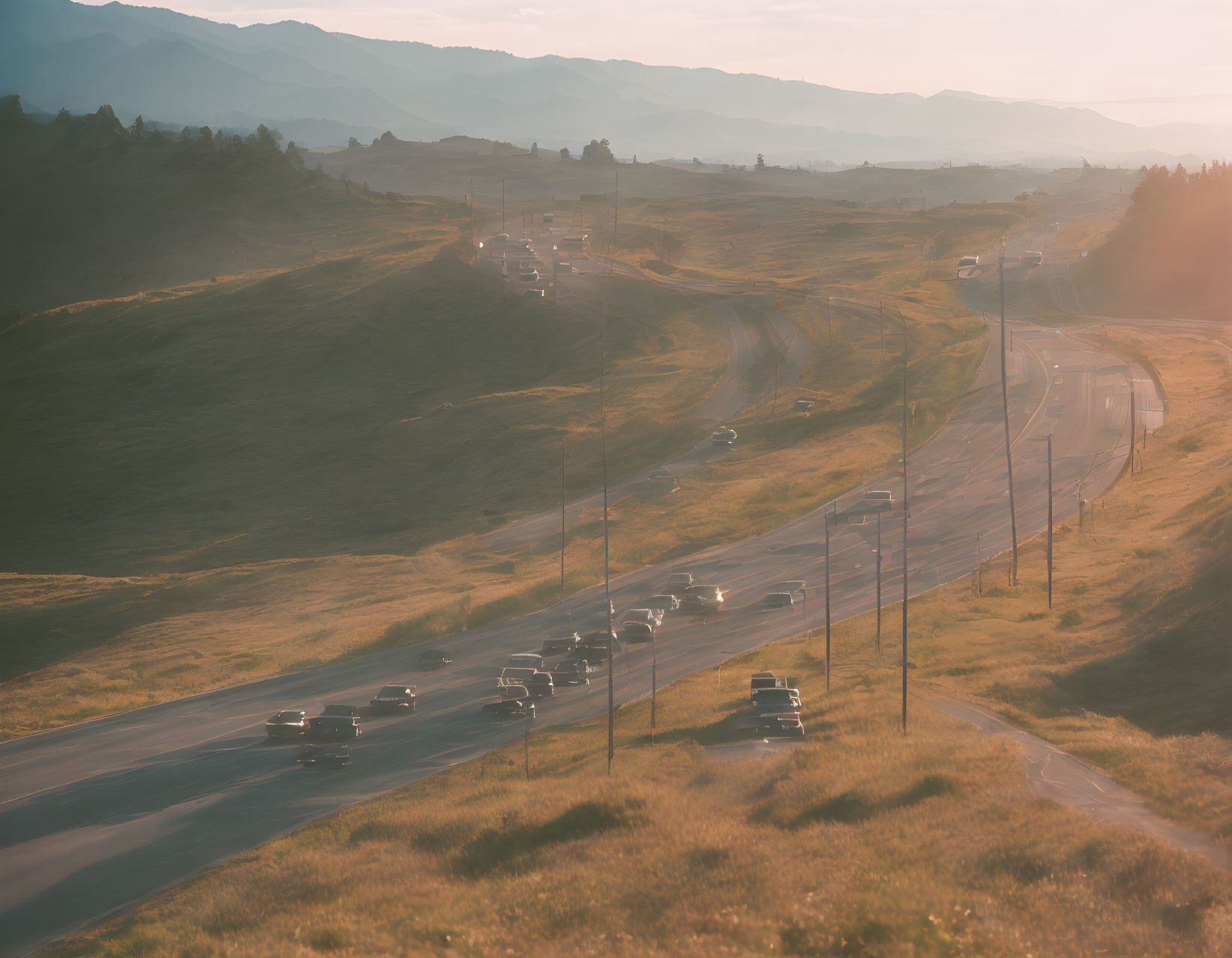 Scenic sunset drive on winding road through rolling hills