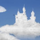 White Castle with Spires on Clouds in Blue Sky