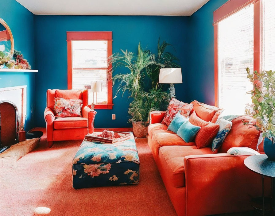 Colorful Living Room with Red-Orange Sofas, Blue Walls, and White Fireplace