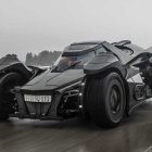 Black Futuristic Car Drives on Snowy Road