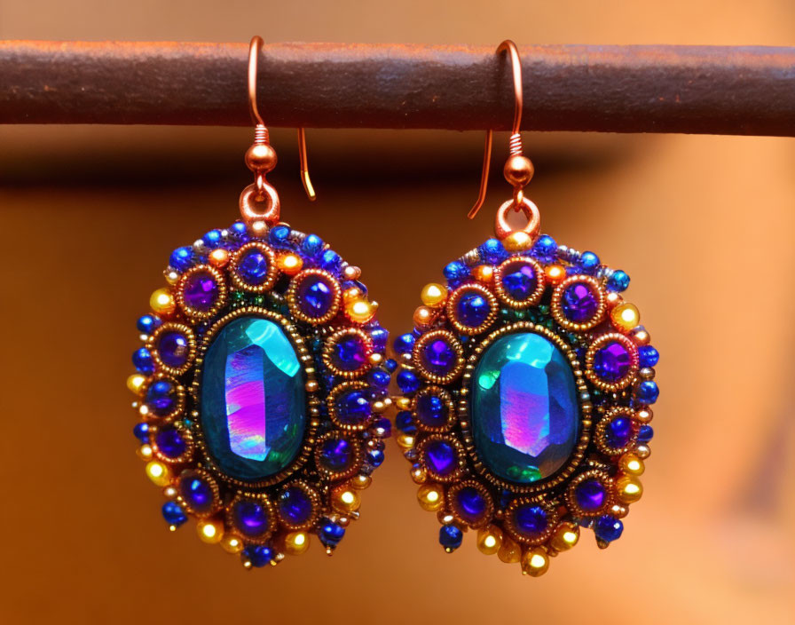 Ornate Earrings with Iridescent Stones and Blue Gold Beads