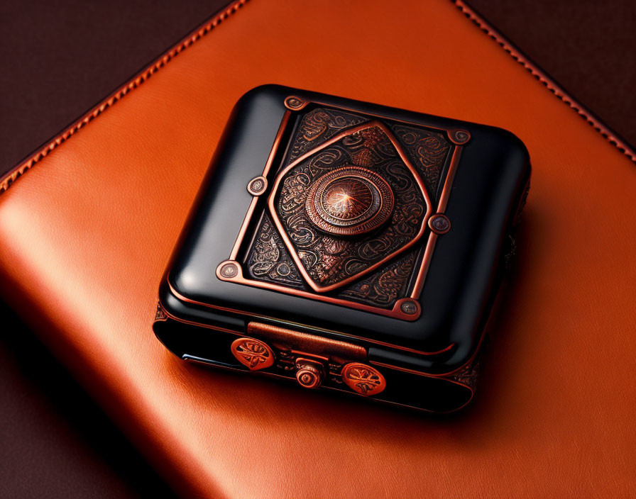 Black and Copper Metal Box with Intricate Designs on Leather Surface