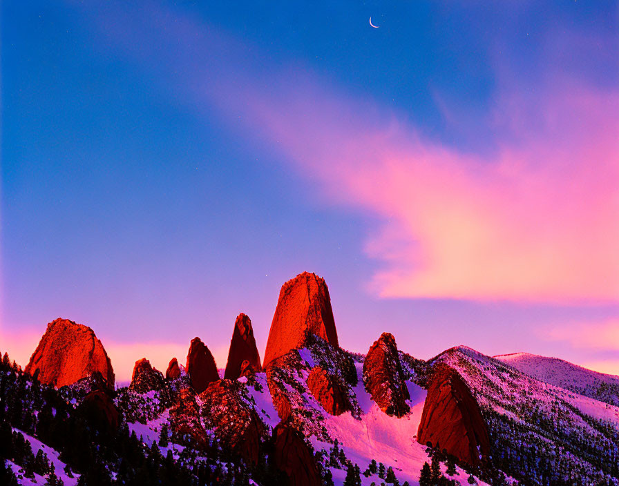 Twilight sky over snow-capped mountain peaks