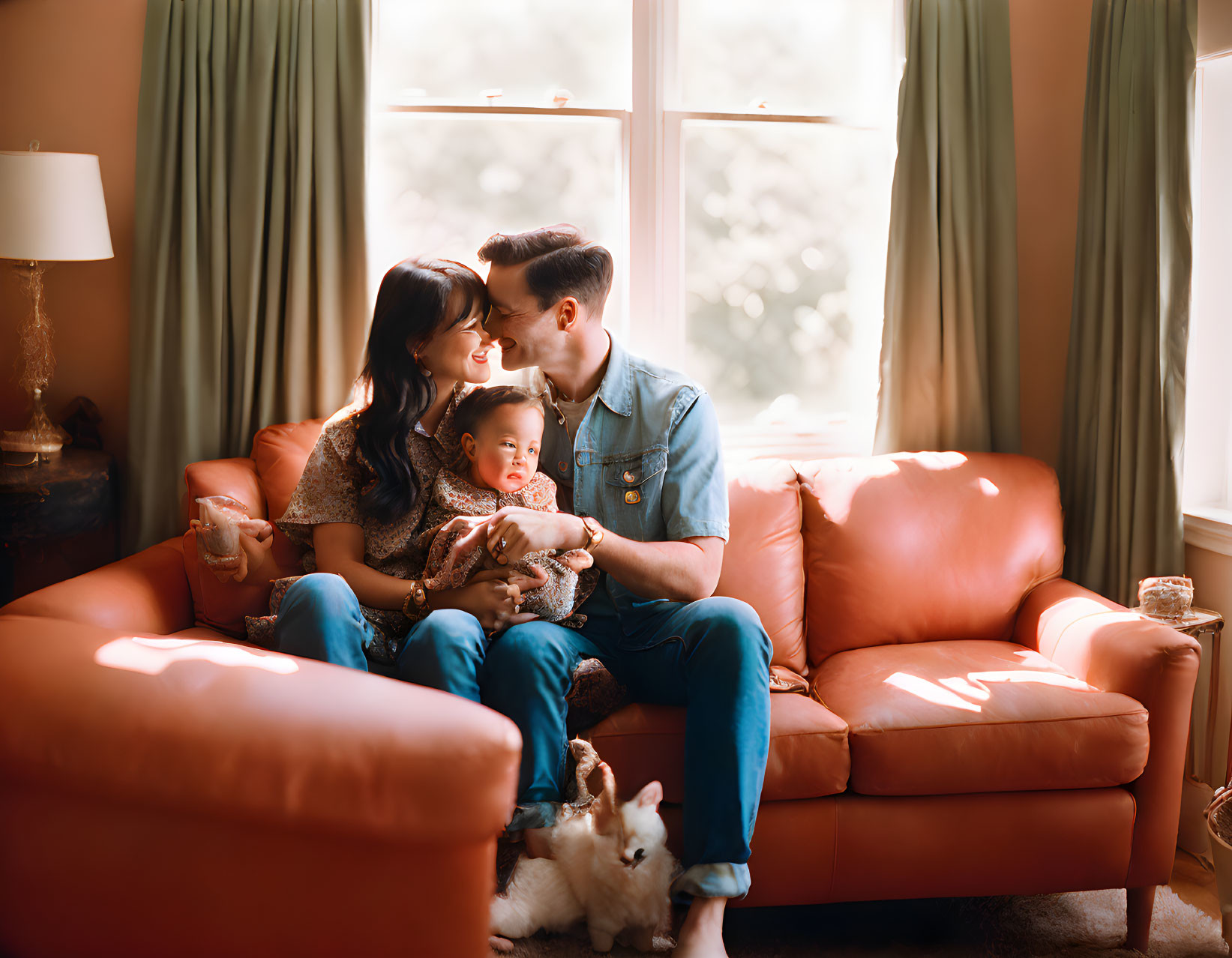 Family with Baby and Dog on Coral Sofa in Warmly Lit Room