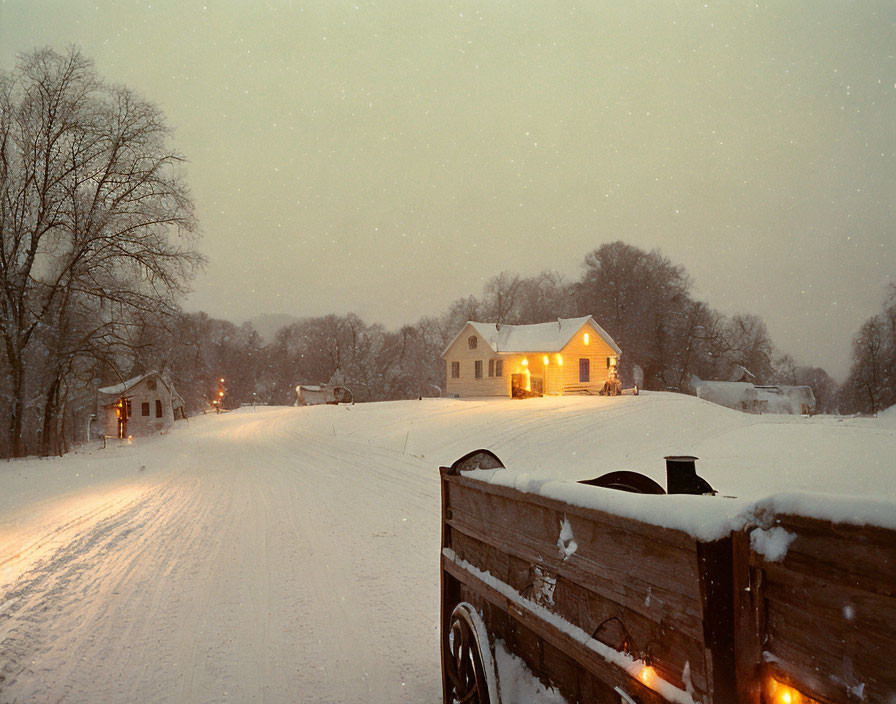 Snowy Night Scene: House with Warm Glow and Wooden Cart