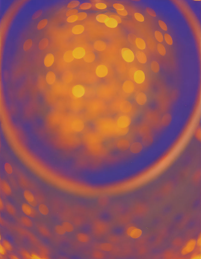 Bokeh light effect with warm golden spots on soft blue and orange background