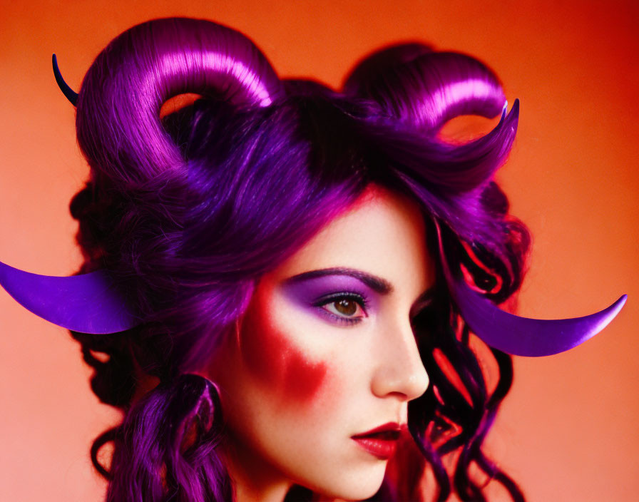 Purple-haired person with integrated purple horns, dramatic makeup, and focused gaze on orange background