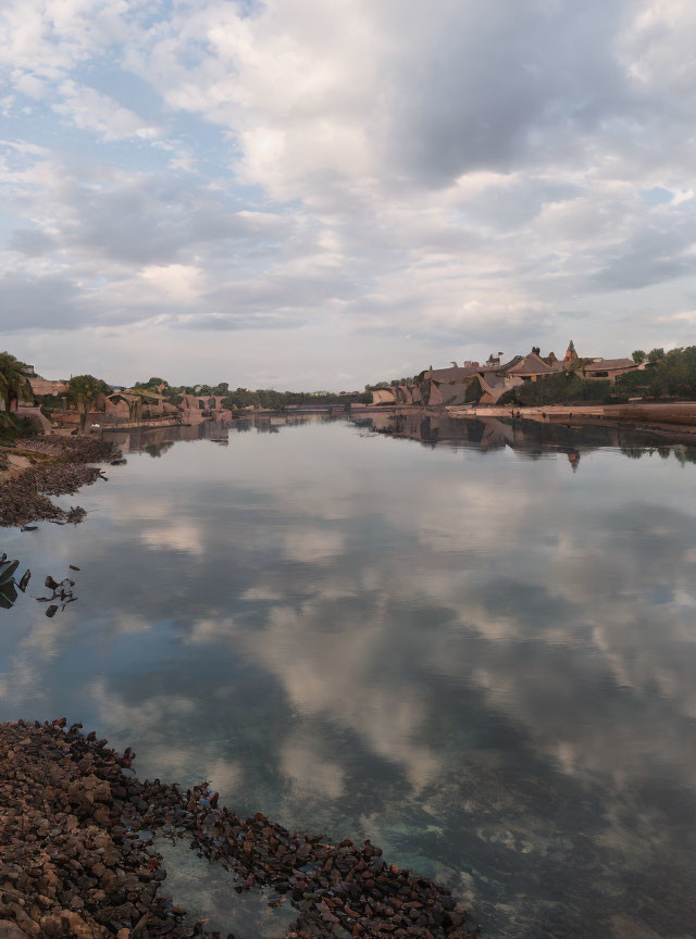 Tranquil river scene with stone bridge and traditional buildings