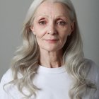 Elderly Woman Portrait with Long Gray Hair and White Top