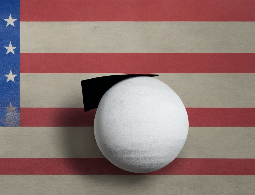 White Sphere with Black Graduation Cap on American Flag Background