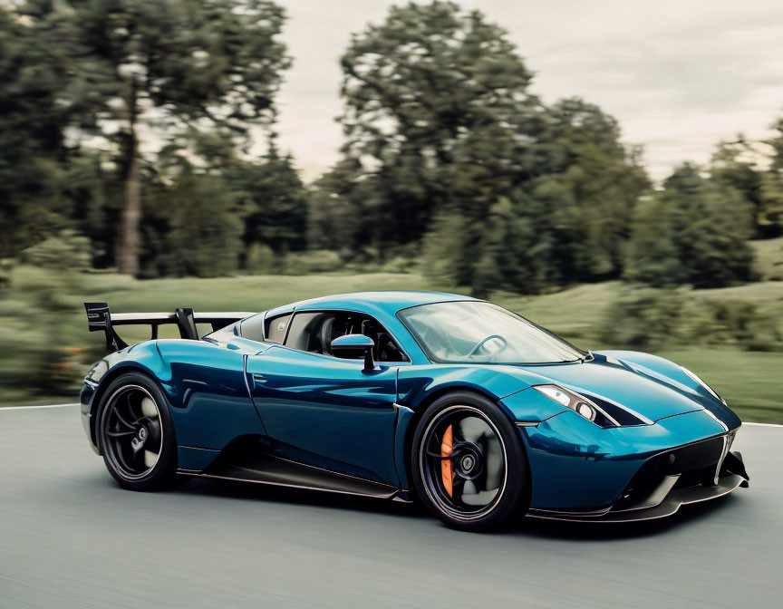 Blue Sports Car with Rear Spoiler Driving Through Green Landscape