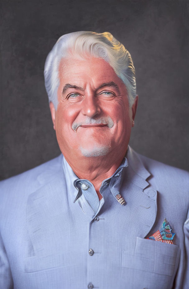 Elderly man in blue shirt smiling on gray background