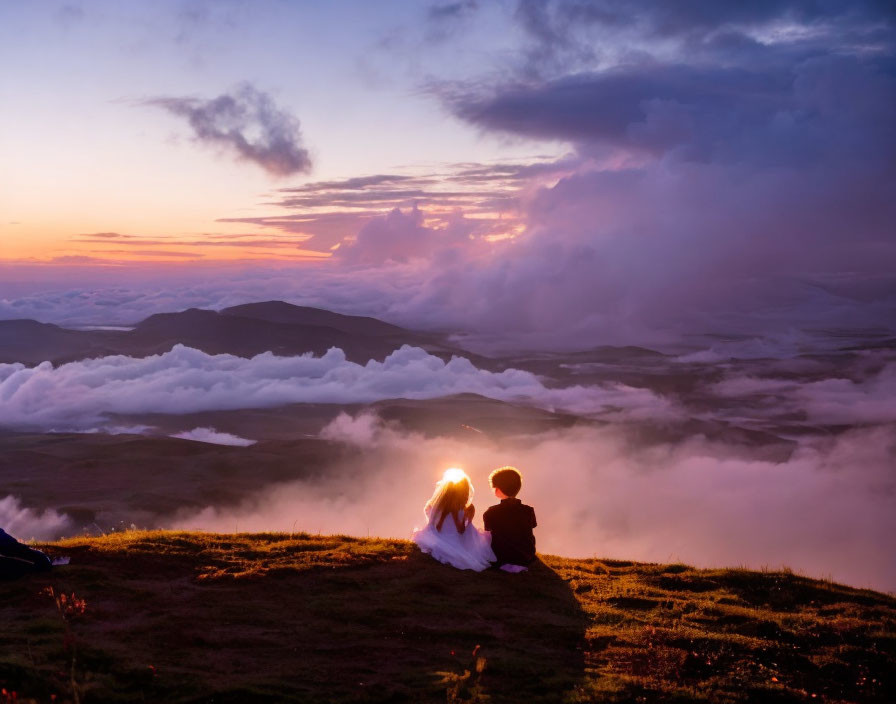 Couple admiring sunset on hilltop with mountains and serene sky