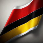 Close-up of wavy German flag with black, red, and yellow stripes on grey background