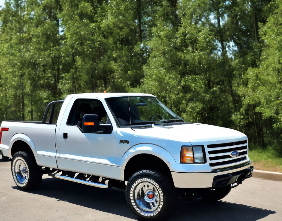 White Ford Ranger Pickup Truck Parked on Asphalt Road Surrounded by Green Trees